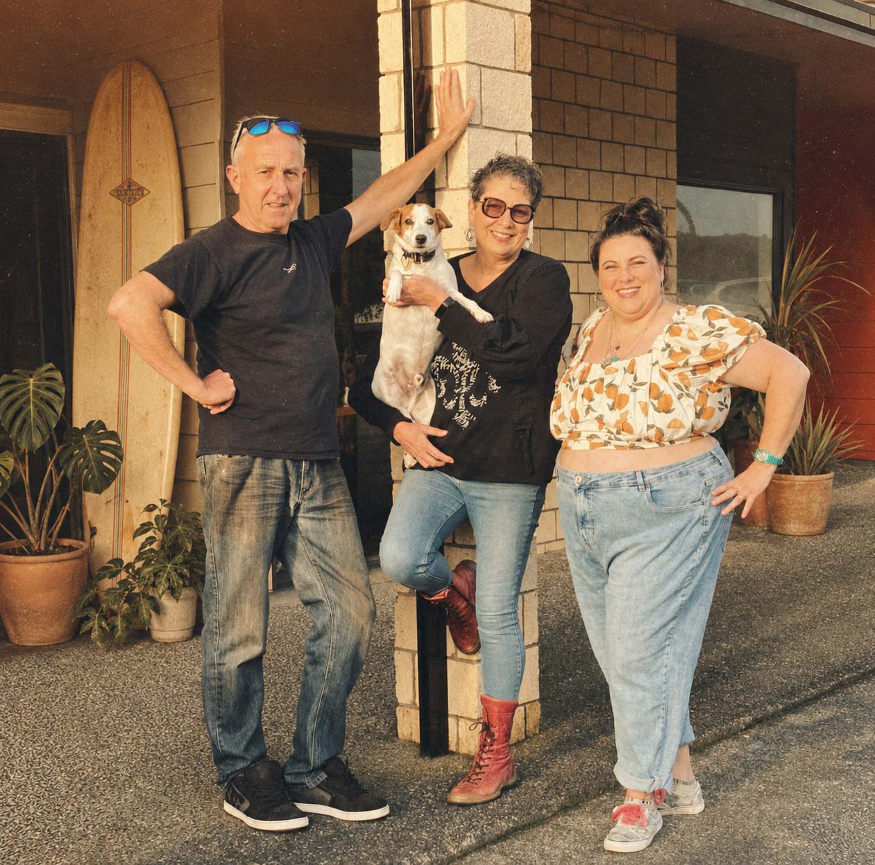 Helen, Fish and Regan outside Smith and Local cafe in Parua Bay with their dog, celebrating the cafe’s past and present in a warm coastal setting.